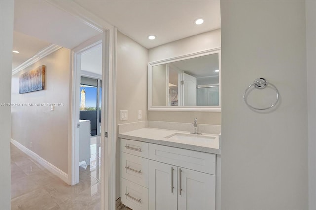 bathroom featuring recessed lighting, vanity, and baseboards