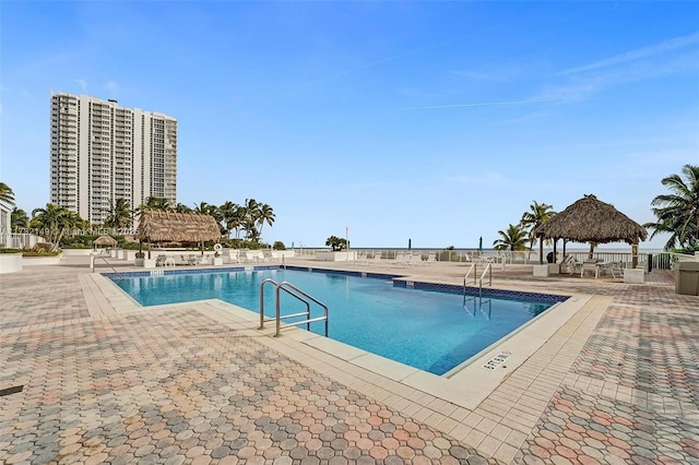 community pool featuring a gazebo and a patio area