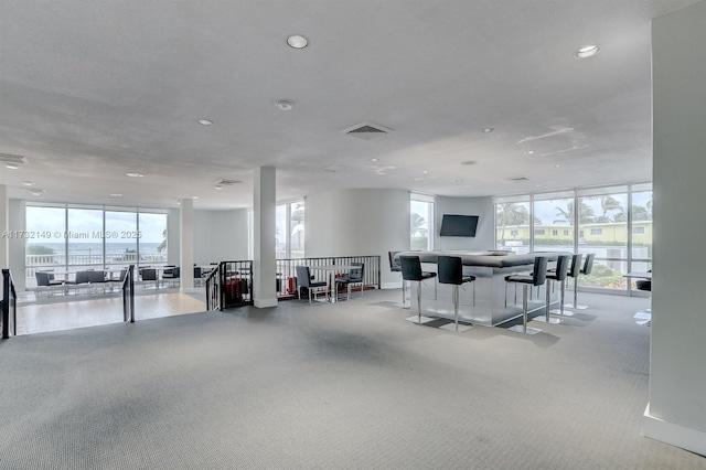 interior space with expansive windows, visible vents, and recessed lighting