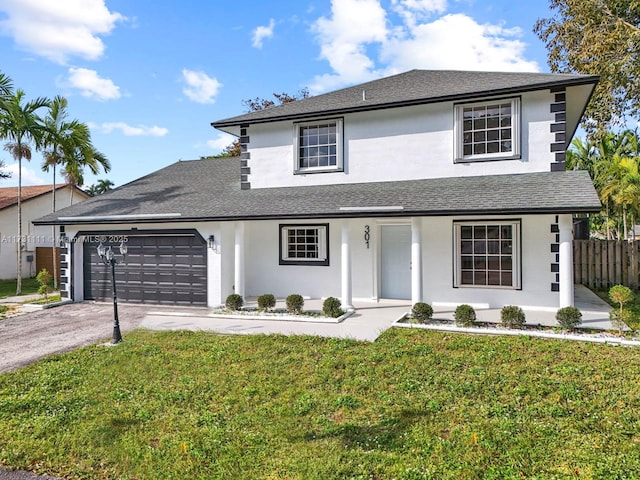 traditional-style home with stucco siding, an attached garage, driveway, and a front lawn