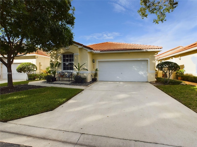 mediterranean / spanish-style house featuring a garage and a front yard