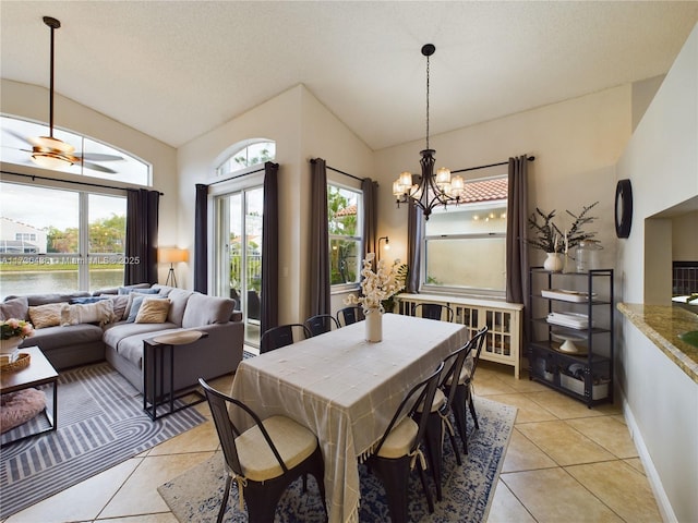 dining room featuring vaulted ceiling, plenty of natural light, and light tile patterned floors