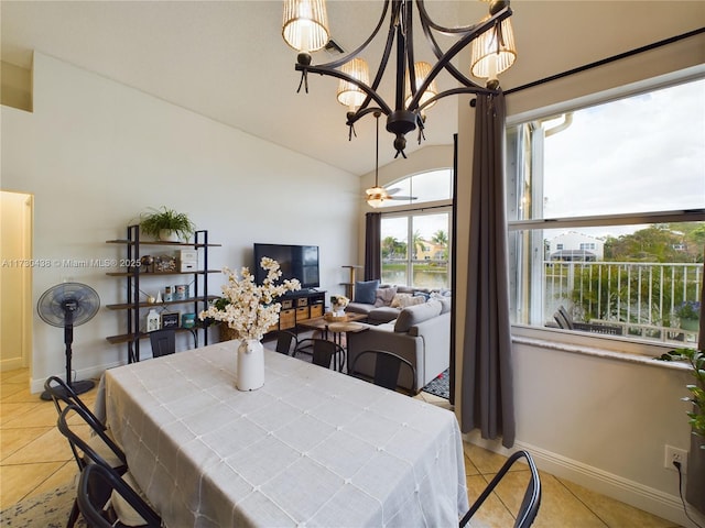 dining room featuring vaulted ceiling, light tile patterned flooring, and an inviting chandelier