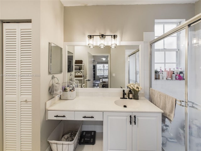 bathroom featuring walk in shower, vanity, and a wealth of natural light