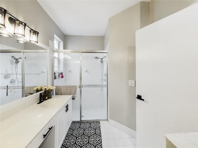 bathroom with vanity, tile patterned floors, and a shower with door