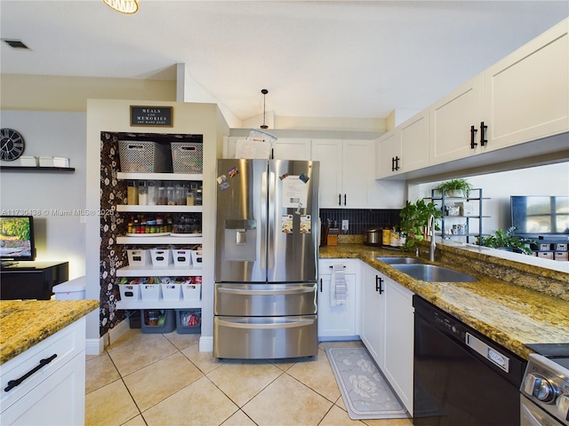 kitchen featuring white cabinetry, stainless steel appliances, sink, and dark stone countertops