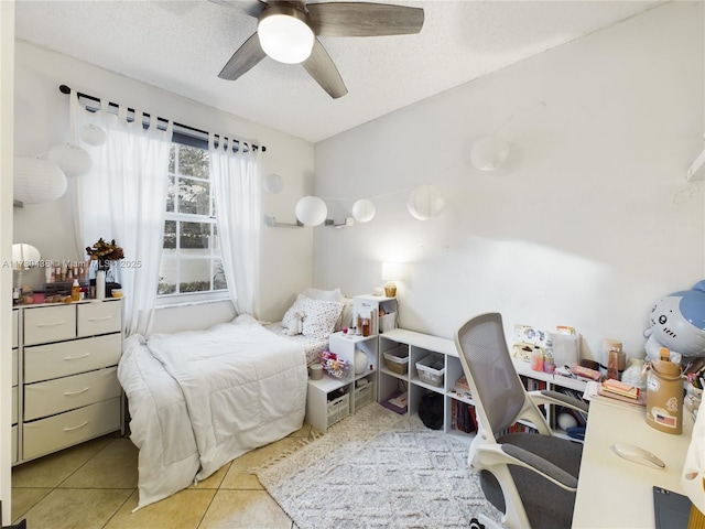 tiled bedroom featuring ceiling fan and a textured ceiling