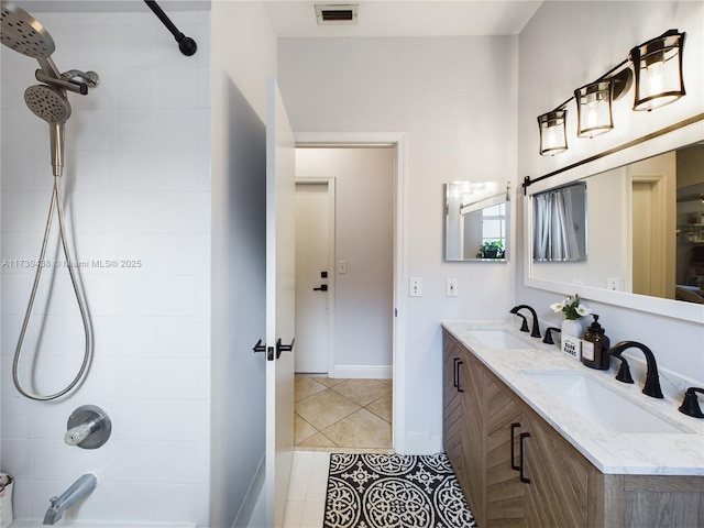 bathroom with tile patterned flooring, vanity, and tiled shower / bath combo