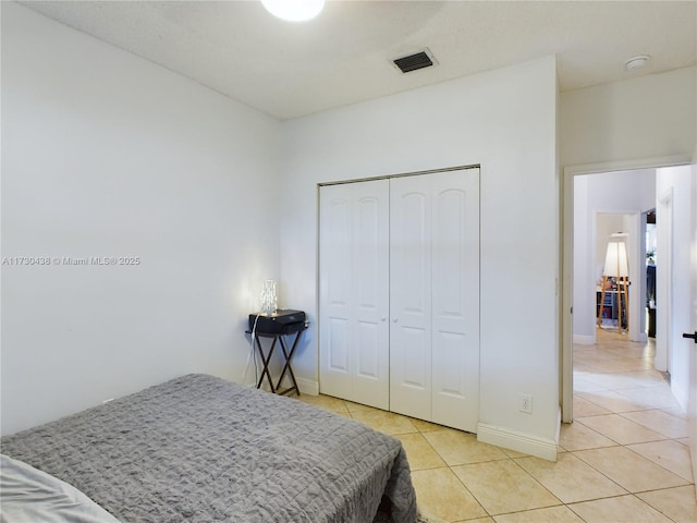 bedroom featuring light tile patterned floors and a closet