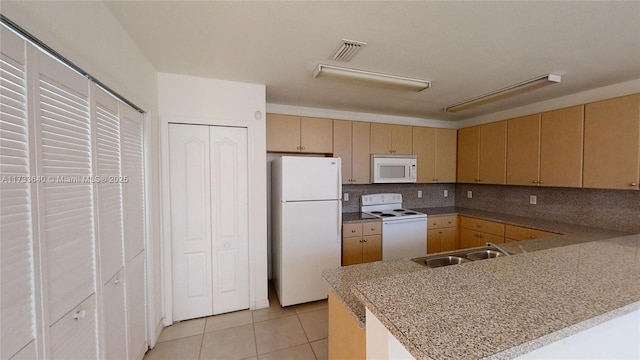 kitchen featuring sink, white appliances, kitchen peninsula, and backsplash