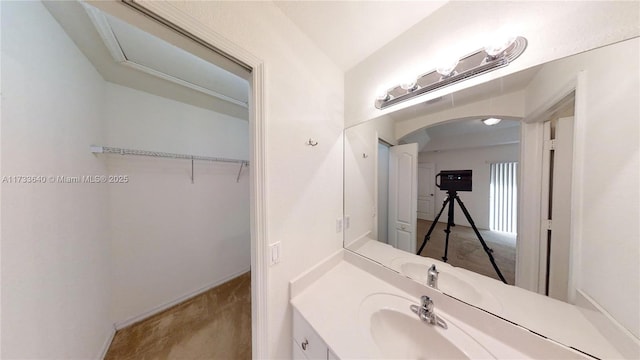 bathroom featuring vanity and vaulted ceiling