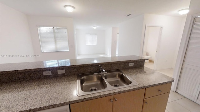 kitchen featuring light tile patterned flooring and sink