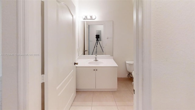 bathroom featuring vanity, toilet, and tile patterned flooring