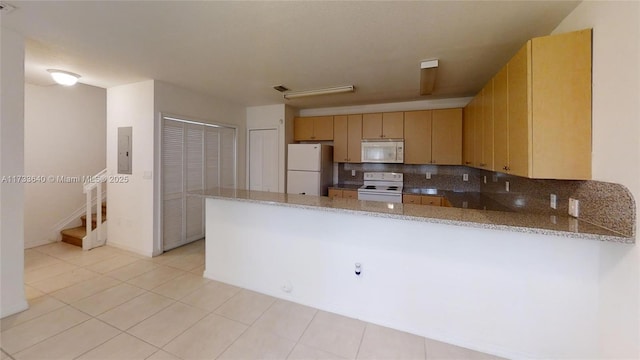 kitchen featuring tasteful backsplash, light brown cabinets, white appliances, and kitchen peninsula