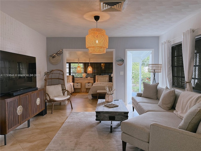 living room featuring light tile patterned floors and a textured ceiling