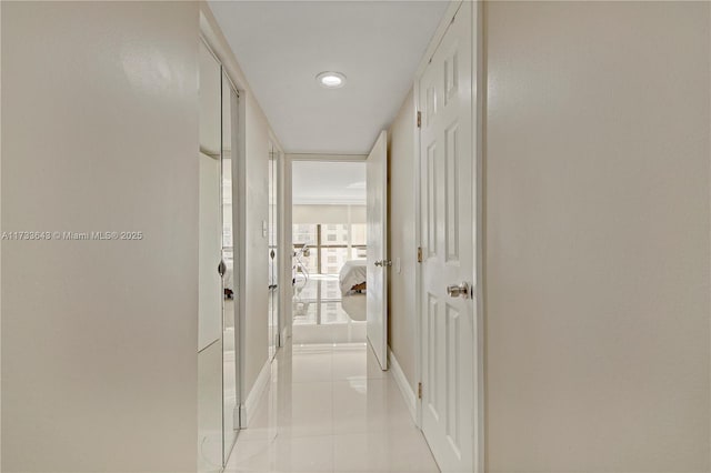 hall featuring light tile patterned flooring