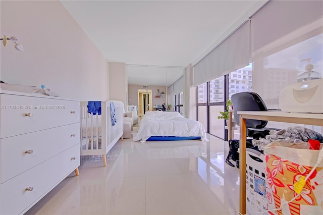 tiled bedroom featuring floor to ceiling windows