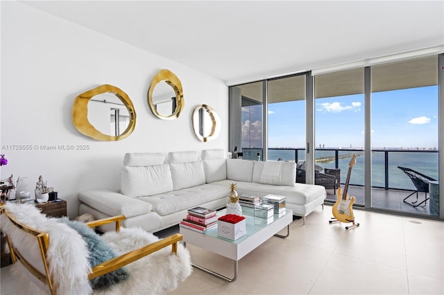 living room with a wall of windows and a water view