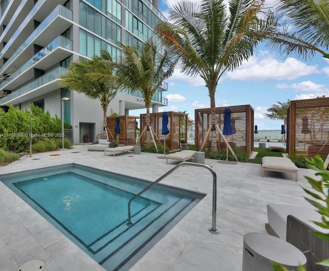 view of pool with a playground and a patio area