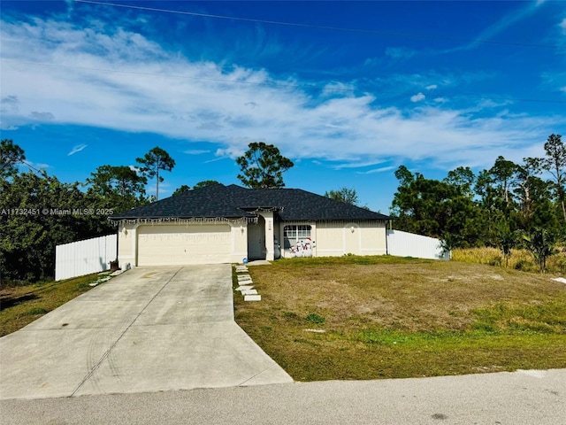 single story home featuring a garage and a front lawn