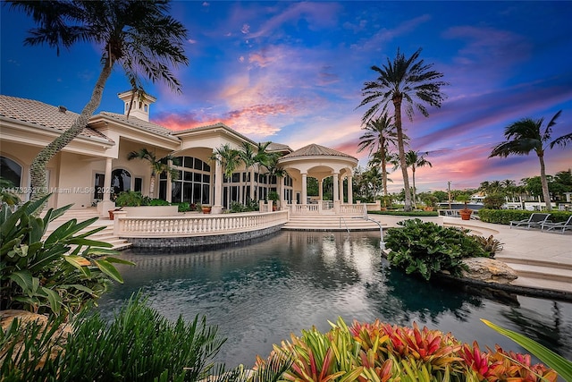 pool at dusk with a patio