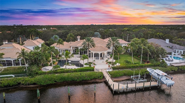 aerial view at dusk with a water view