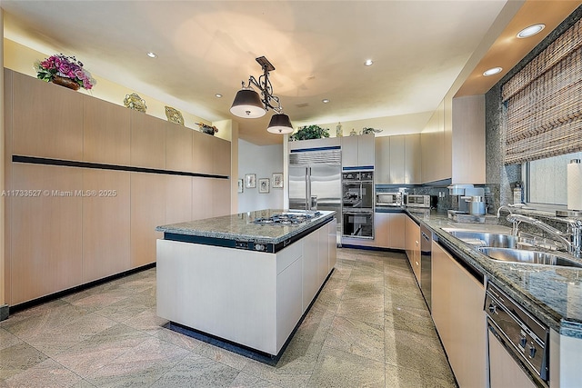 kitchen featuring sink, tasteful backsplash, hanging light fixtures, a kitchen island, and black appliances