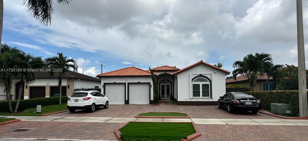 mediterranean / spanish-style home with a garage