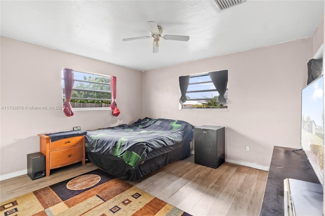 bedroom featuring light hardwood / wood-style floors and ceiling fan