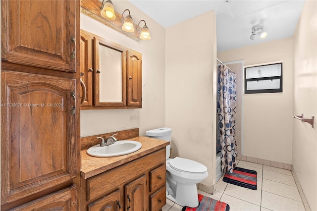 bathroom with vanity, toilet, curtained shower, and tile patterned flooring