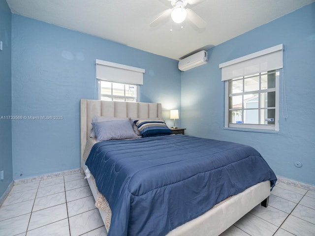 bedroom featuring light tile patterned flooring, ceiling fan, and a wall mounted air conditioner