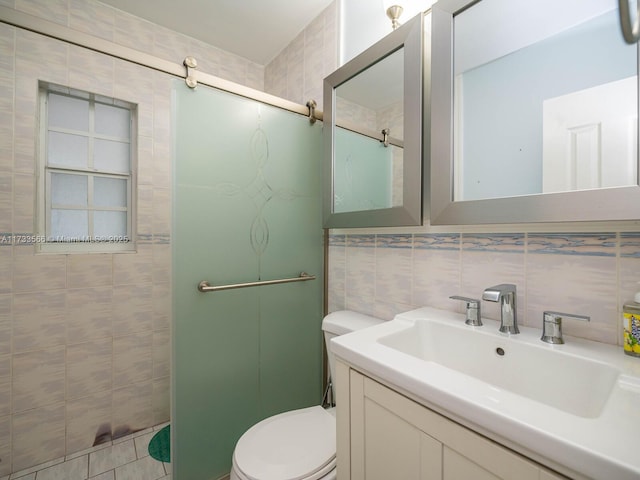 bathroom featuring toilet, a shower with shower door, tasteful backsplash, tile walls, and vanity