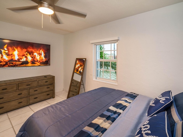 tiled bedroom featuring ceiling fan