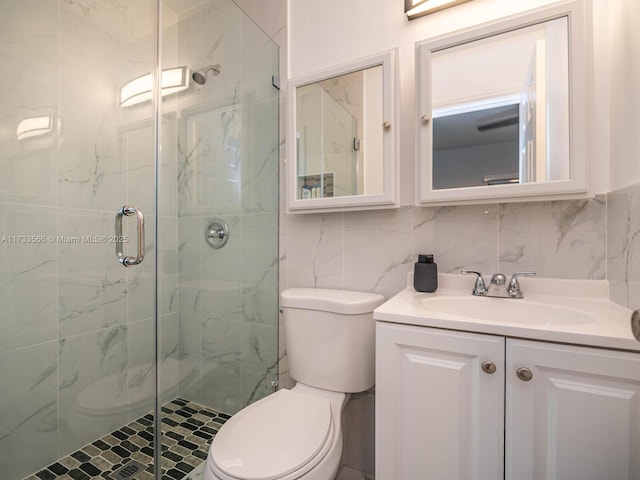 bathroom featuring an enclosed shower, vanity, tasteful backsplash, and toilet