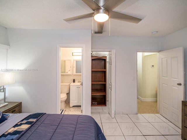 bedroom featuring ceiling fan and connected bathroom