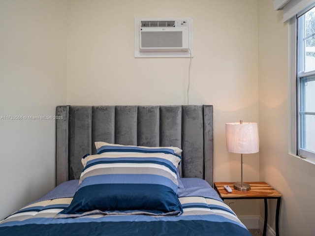 bedroom featuring a wall mounted AC