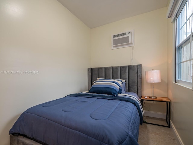 bedroom featuring lofted ceiling and a wall unit AC