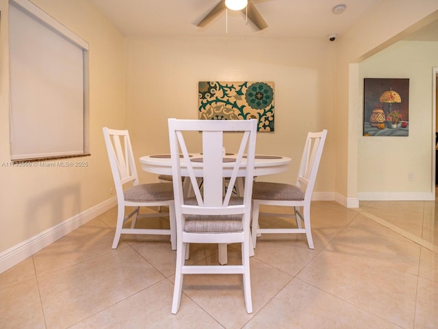 tiled dining area featuring ceiling fan