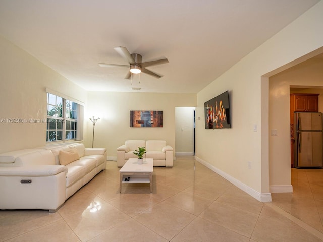 living room featuring light tile patterned floors and ceiling fan