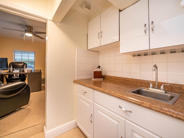 kitchen with light tile patterned flooring, sink, ceiling fan, decorative backsplash, and white cabinets