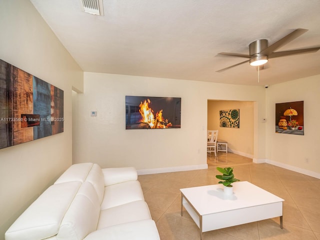 living room with light tile patterned floors and ceiling fan