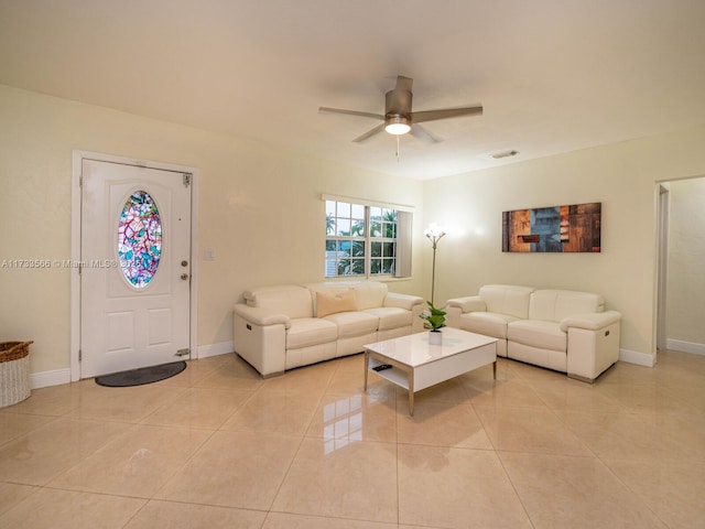 tiled living room with ceiling fan