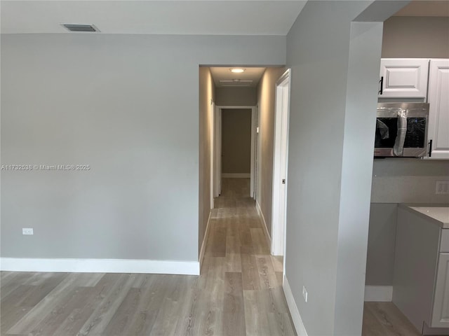 hallway with light wood-type flooring