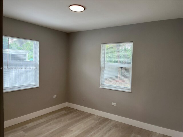 unfurnished room with a wealth of natural light and light wood-type flooring