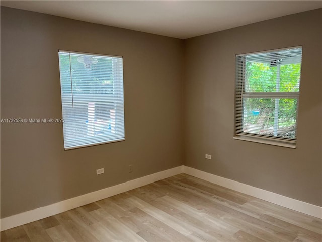 unfurnished room with light hardwood / wood-style flooring and plenty of natural light