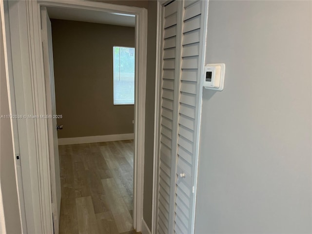 hallway with light hardwood / wood-style flooring