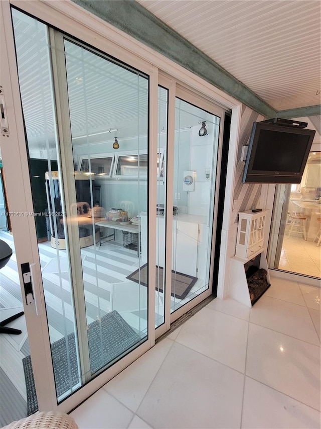 doorway to outside with tile patterned flooring