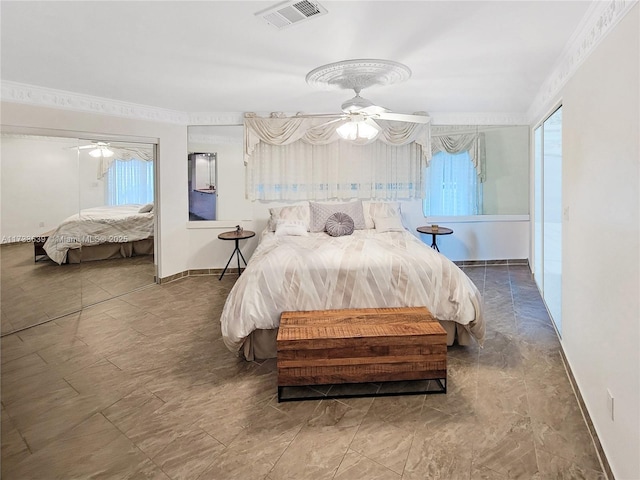 bedroom with ornamental molding and multiple windows