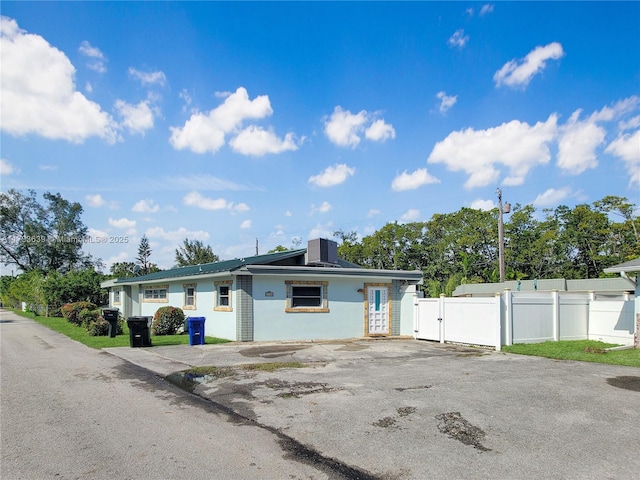 ranch-style house featuring cooling unit