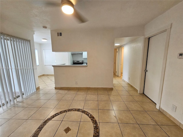 empty room with light tile patterned flooring and ceiling fan